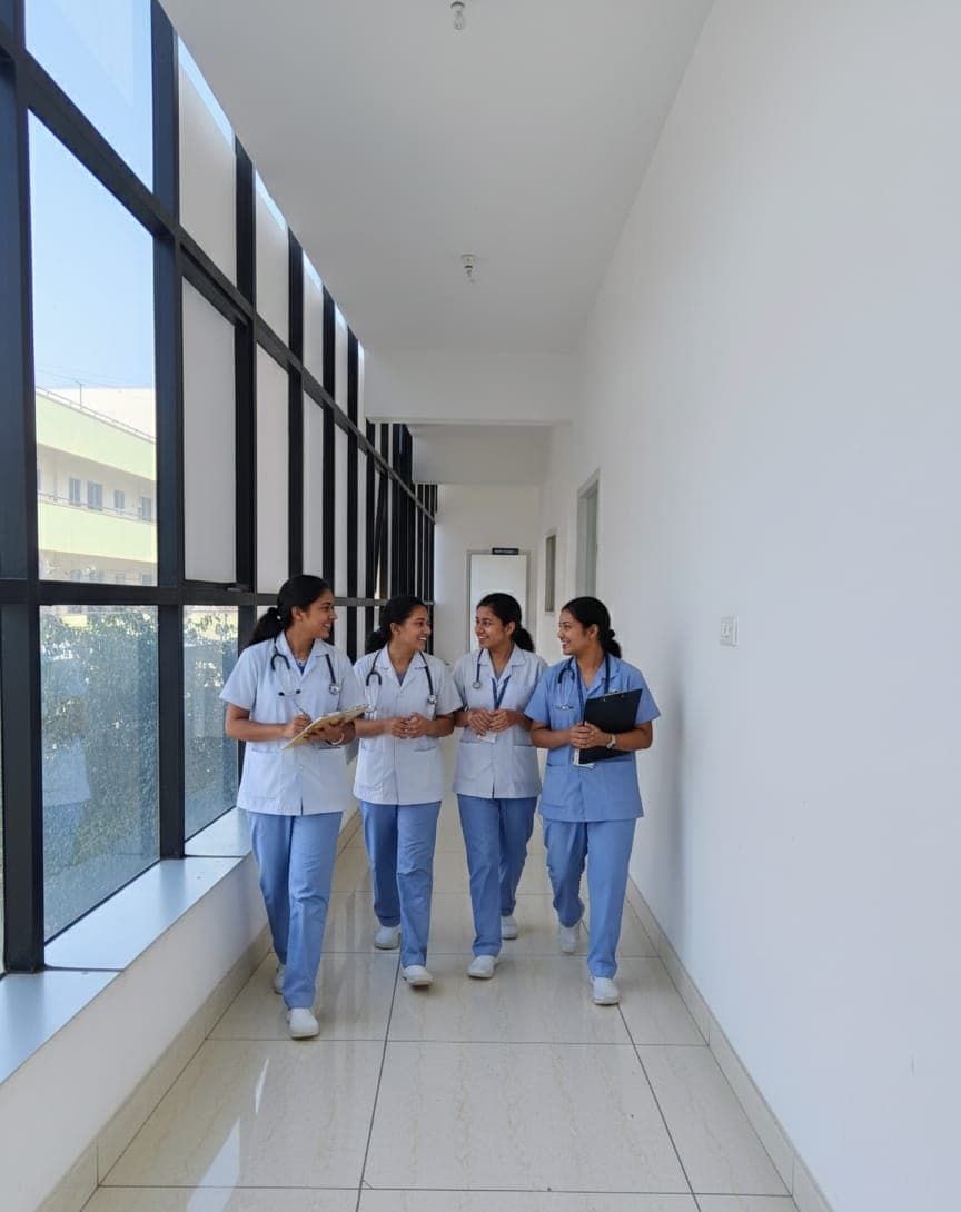 Nursing students in scrubs walking down a hospital corridor